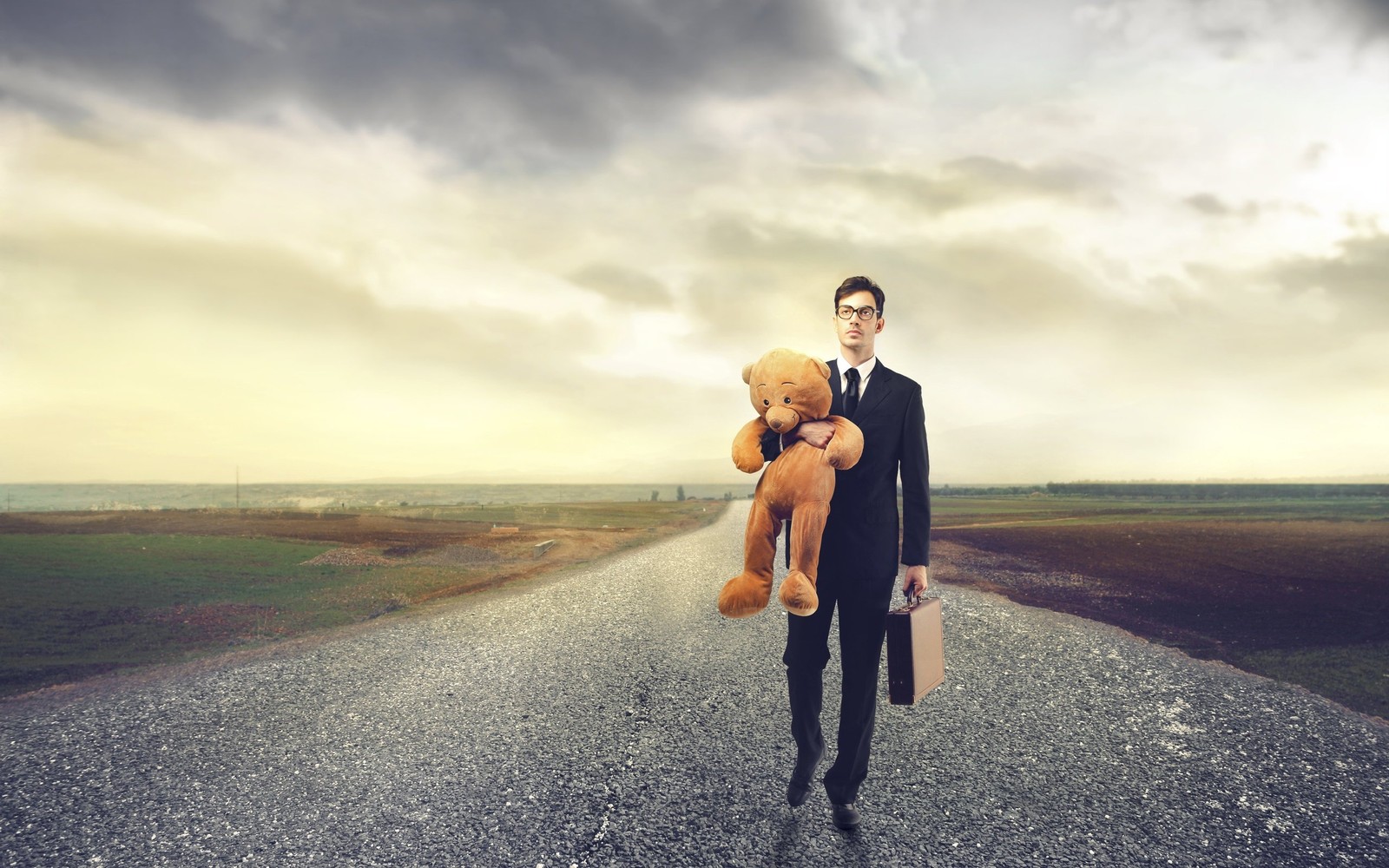 Arafed man in a suit holding a teddy bear walking down a road (man, romance, cloud, fun, person)