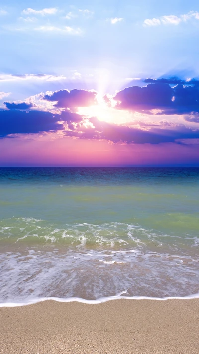 Colorful Sunrise Over Tranquil Beach and Sea