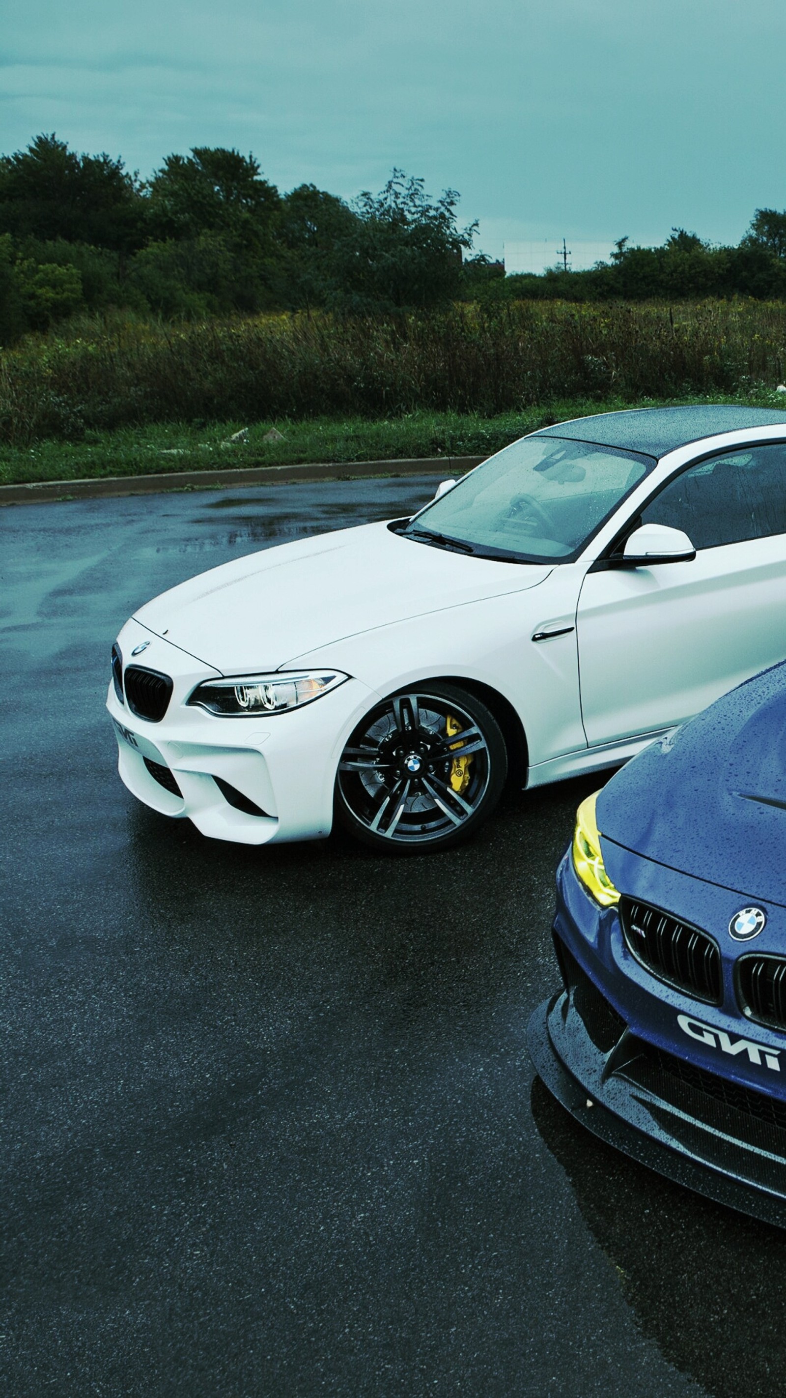 Two cars parked in a parking lot with one blue and the other white (1080p, bmw, cars, coupe, hd)