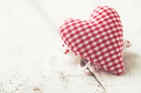 Red Plush Heart Toy on Rustic Wood