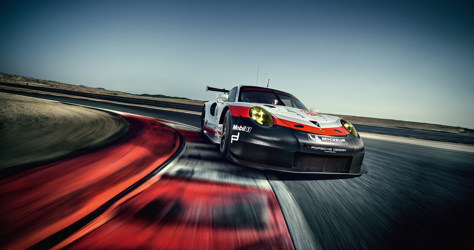 A close up of a car driving on a track with motion bluring (porsche, car, porsche 911 gt3 rsr, grand tourer, sports car racing)