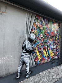 Child Peeking Behind a Colorful Mural in Miami's Street Art Scene