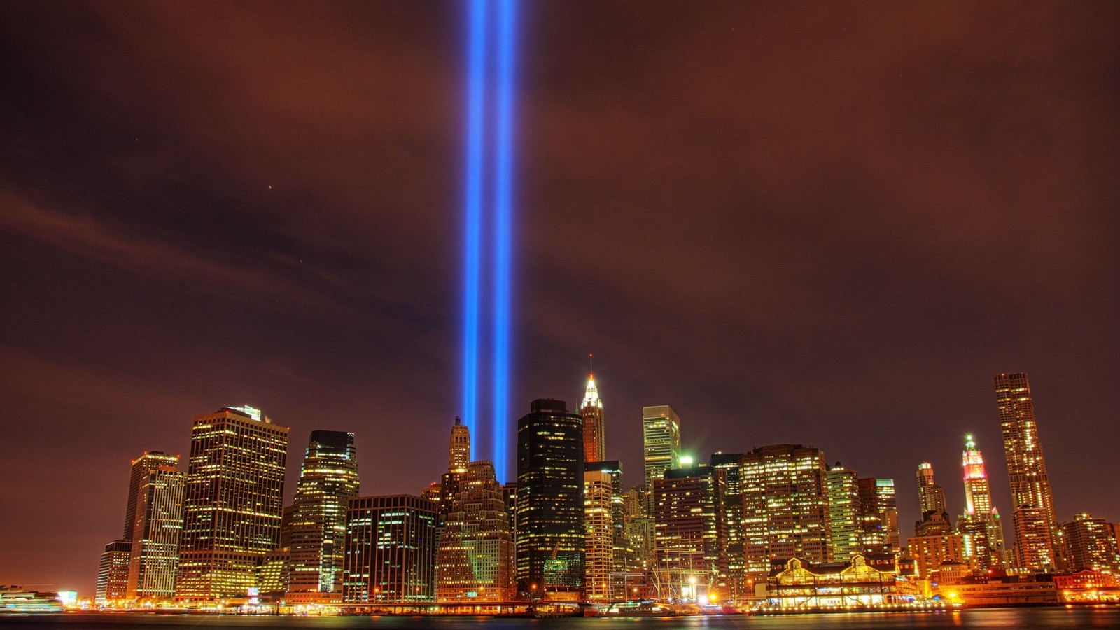 Arafed view of a city skyline with a light beam in the sky (city, cityscape, urban area, landmark, metropolitan area)