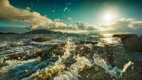 Sunlit Waves Crashing on Rocky Shoreline