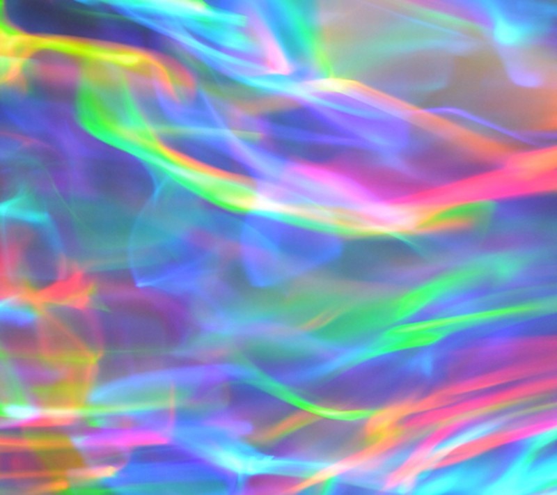 A close up of a colorful background with a blurry image of a person (colors, holograma, holographic)