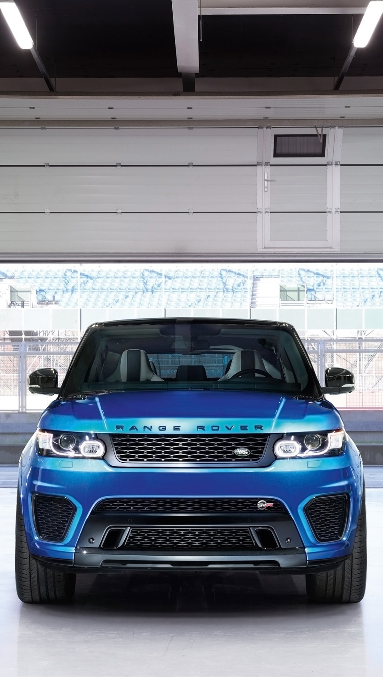 A close up of a blue range rover parked in a garage (blue, car, range rover)