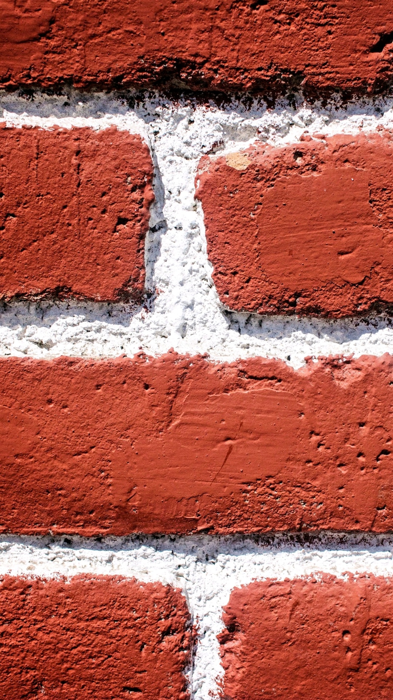 A close up of a brick wall with a white border (other, red, wall, walls)