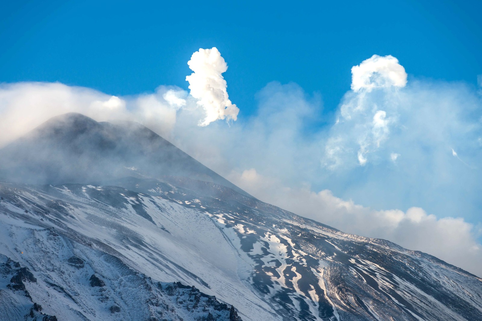 A view of a mountain with a cloud of smoke coming out of it (stratovolcano, lava, mount etna, volcano, mountain)