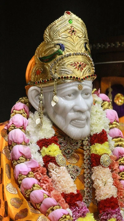 Sai Nath adorned with floral garlands and a golden crown, radiating spirituality and devotion.