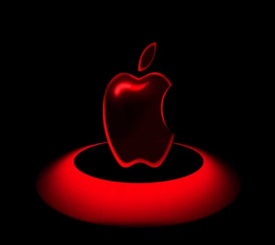 Logo de manzana roja iluminada sobre un fondo oscuro