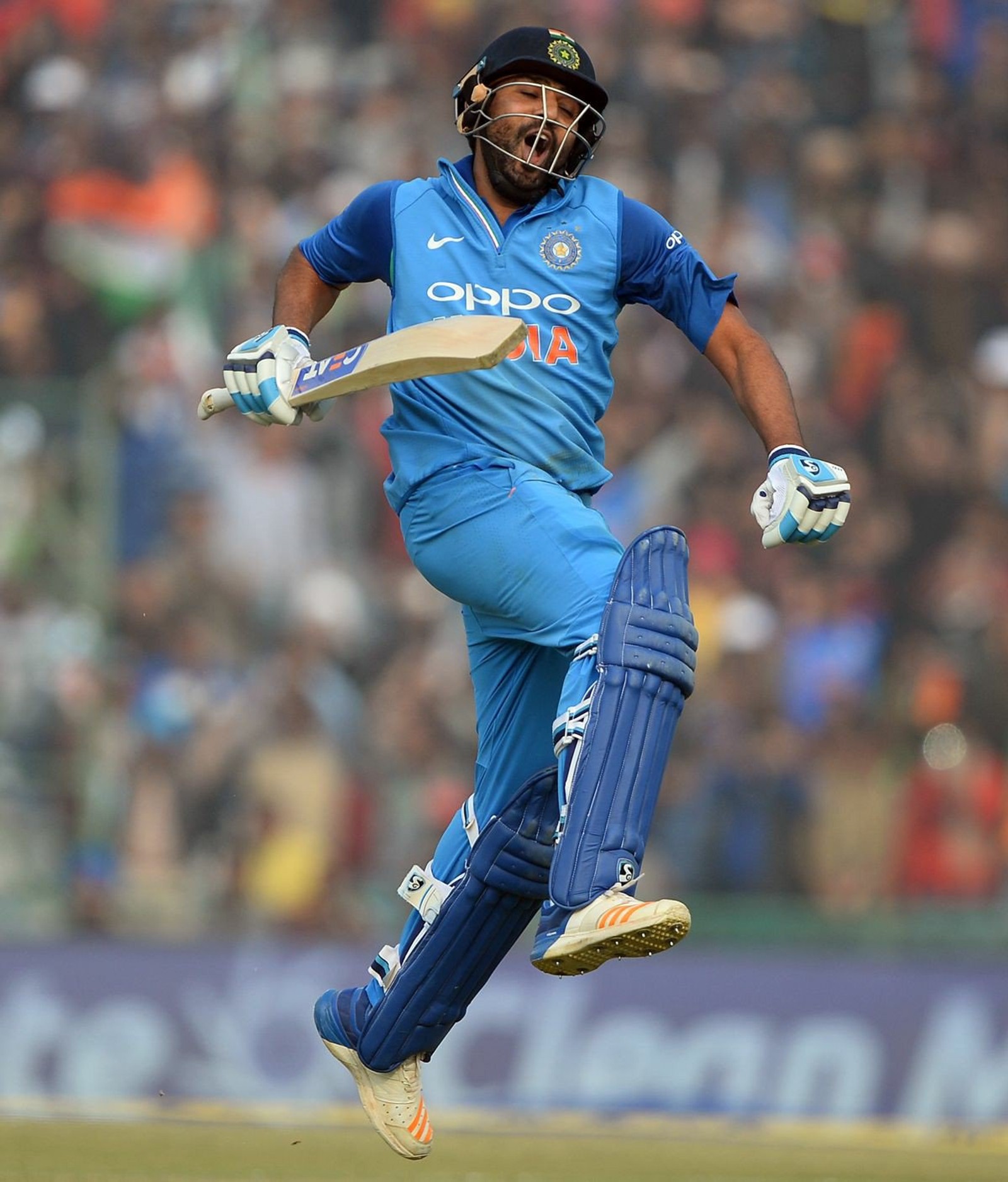 Arafed cricket player in blue uniform jumping in the air (cricket, hitman, india, rohit sharma)