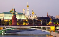 Moscow Kremlin and Red Square skyline at dusk, showcasing iconic towers and the Moskva River.