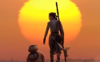 Rey und BB-8 gegen einen goldenen Sonnenuntergang