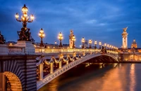 Pont Alexandre III la nuit : une vue époustouflante du pont emblématique de Paris avec la Tour Eiffel en arrière-plan.