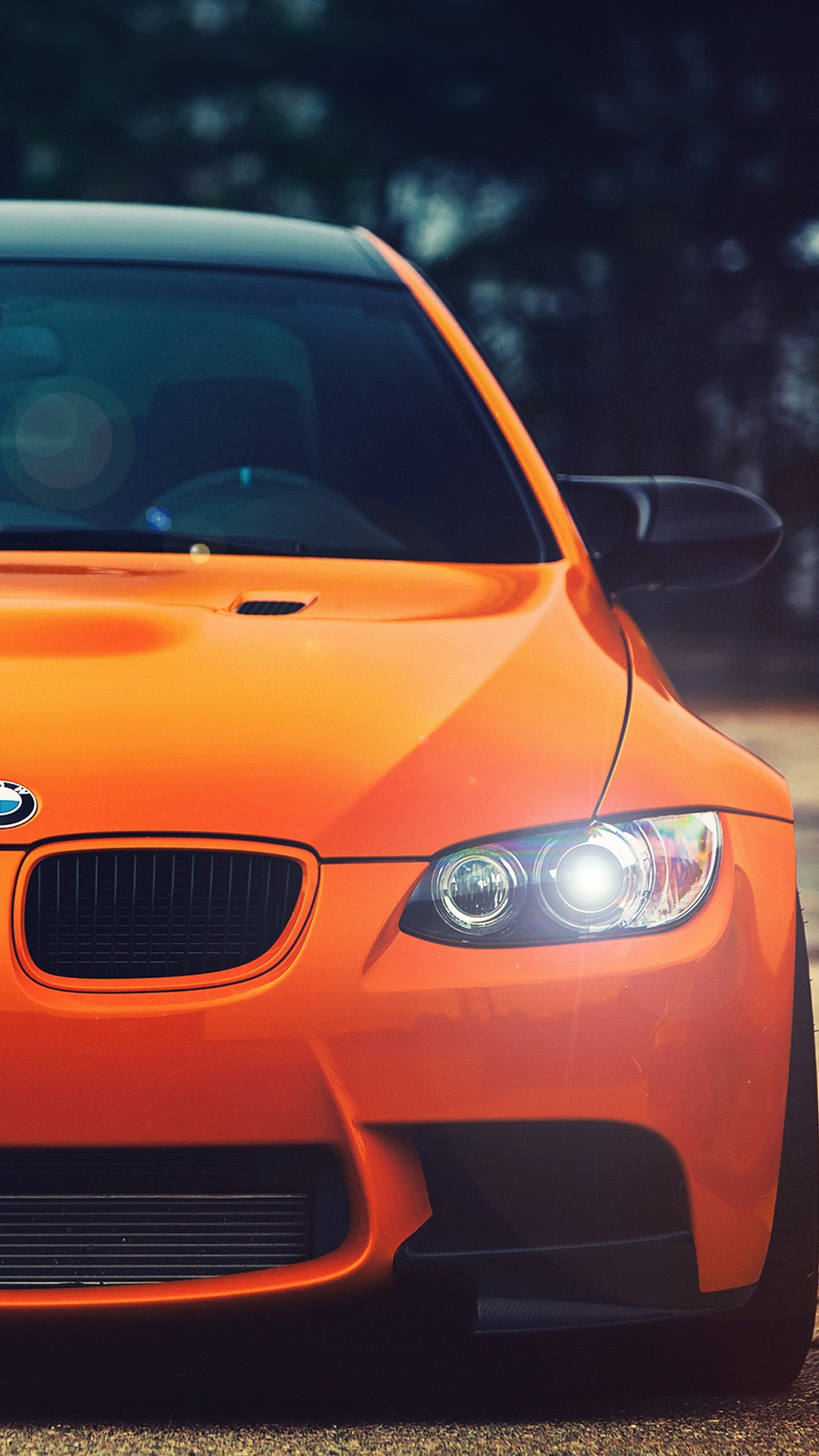 Bmw car with headlights turned on in front of trees (bmw, car, german, orange)