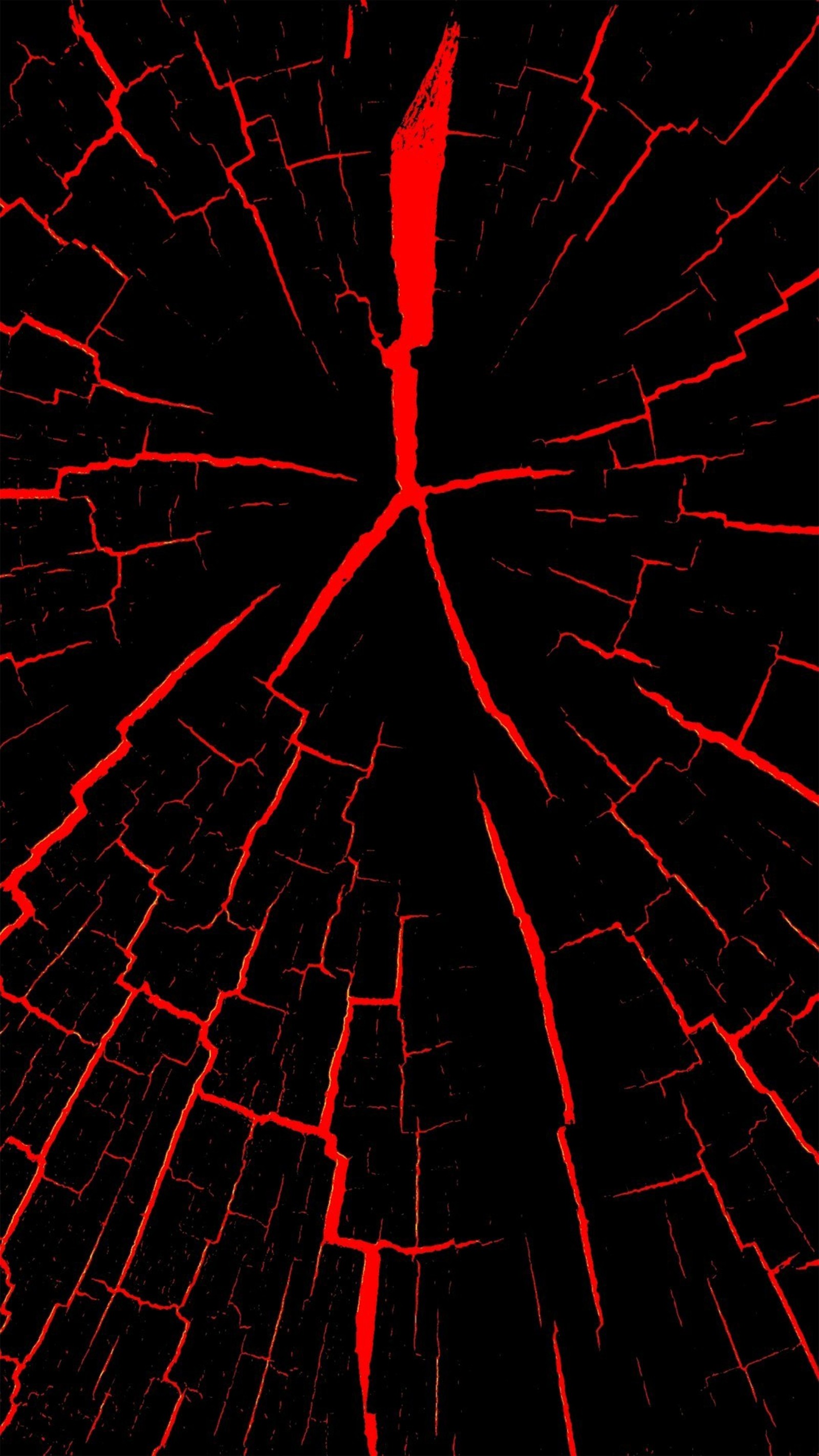 A close up of a red and black cracked glass with a red light (black, cracked, screens, theme, marble)