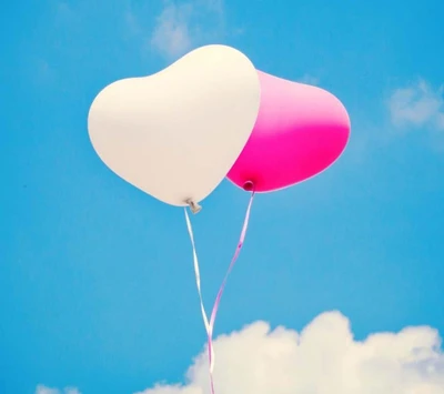 Love in the Sky: Heart-Shaped Balloons Against a Bright Blue Background