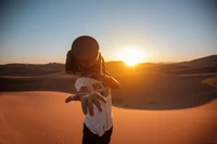 Photographer Capturing the Golden Horizon in the Sahara Desert