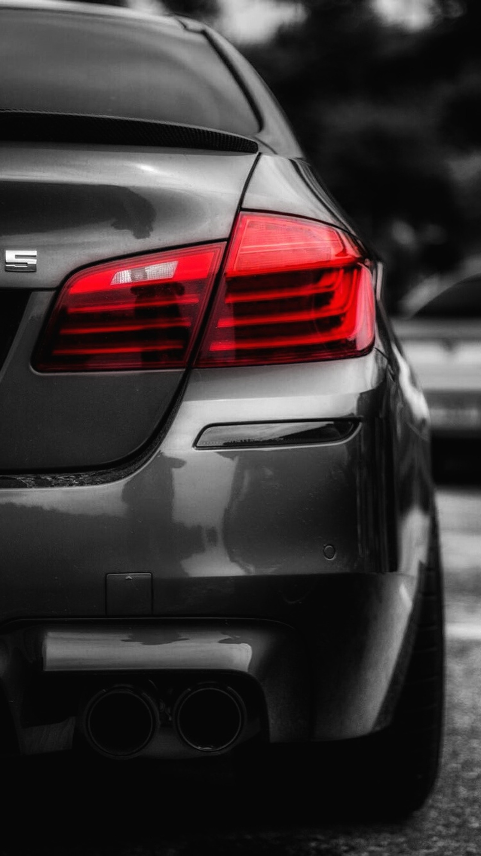 A close up of a car parked on a street with other cars in the background (auto, bmw, car, f10, m power)