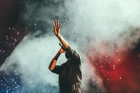 A singer performing under a dynamic sky of lights and smoke, capturing the essence of music and atmosphere.