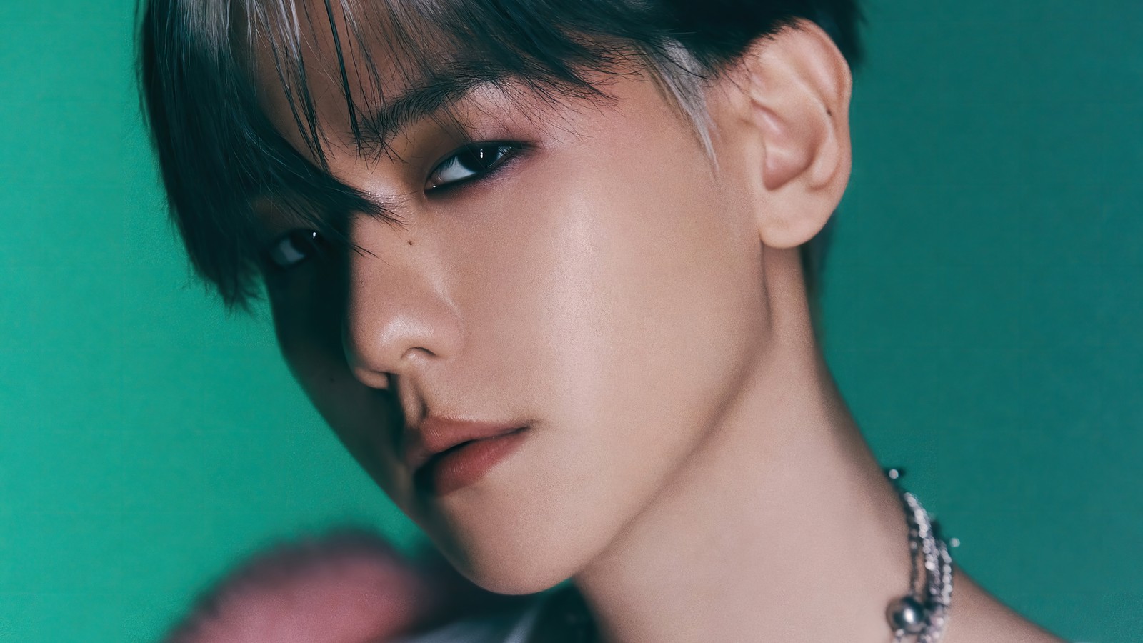 Primer plano de una persona con un collar sobre un fondo verde (baekhyun, 백현, byun baek hyun, 변백현, exo)