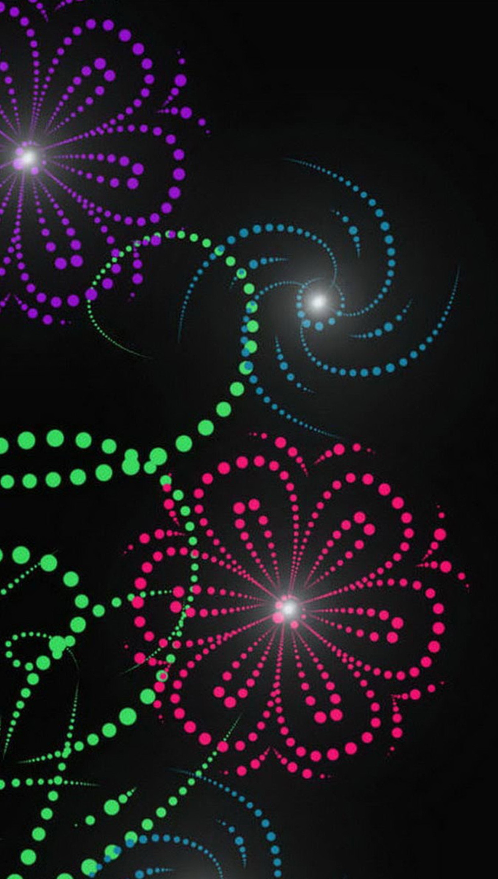 A close up of a clock with a black background and colorful fireworks (flower, glow)