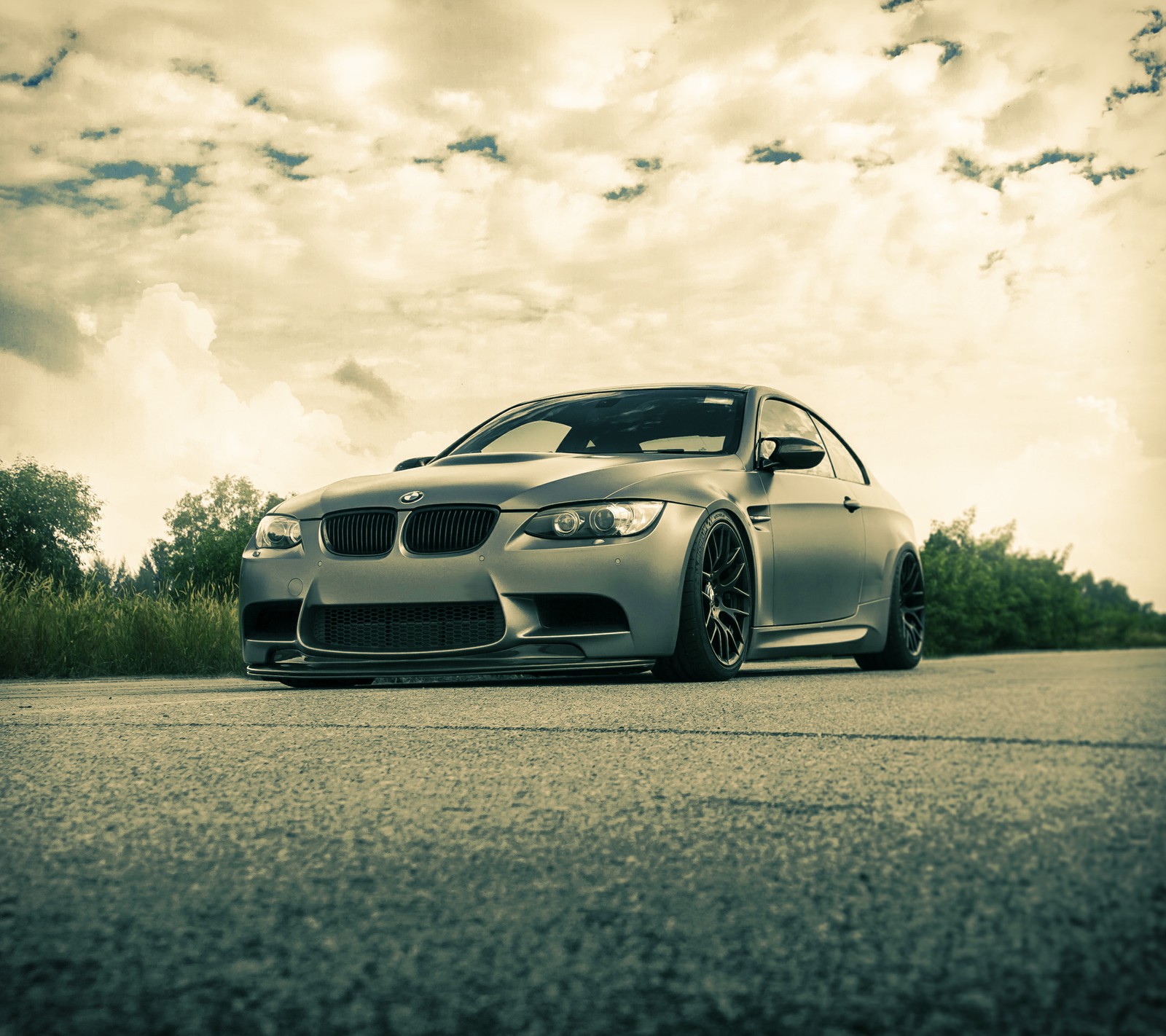 Arafed view of a car parked on a road with a cloudy sky in the background (bmw, coupe, e92, m3, modified)