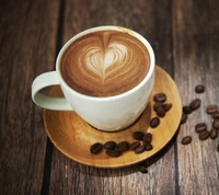 Heart-Shaped Latte Art with Coffee Beans on Wooden Table