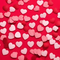 Scattered Red and Pink Hearts on a Vibrant Background