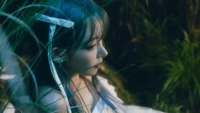 Miyawaki Sakura in a serene moment, surrounded by lush greenery, embodying the "featherly lotus" concept.