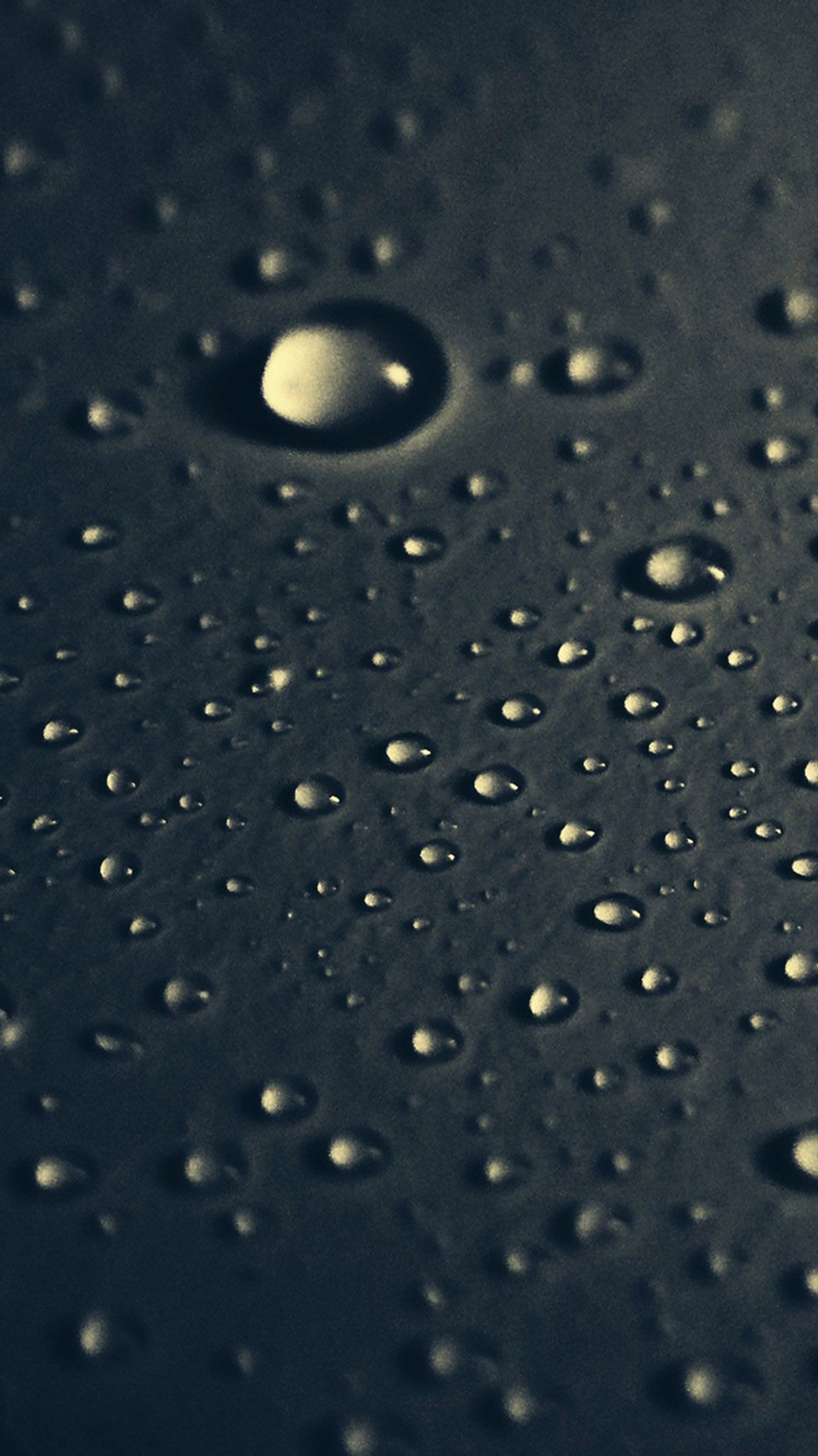 A close up of a black surface with water droplets on it (black, dark, drop)