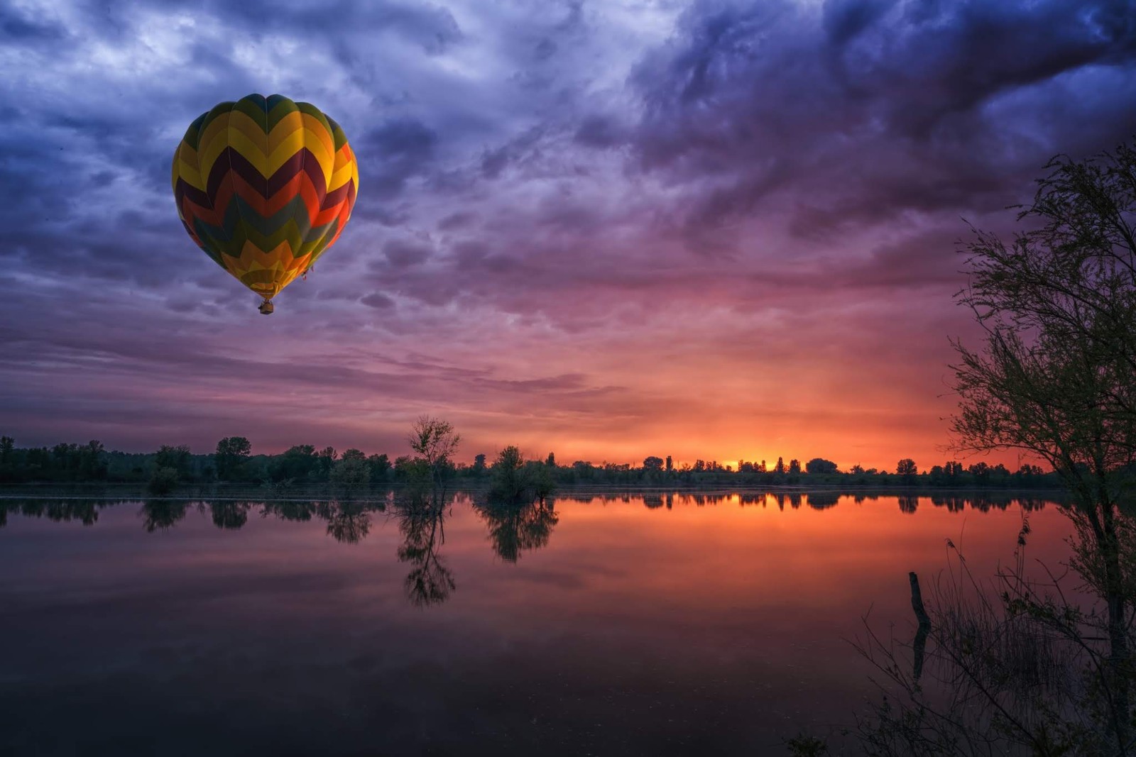 Arafed balloon flying over a lake at sunset with a sky background (microsoft surface, microsoft surface studio, surface, microsoft, microsoft corporation)