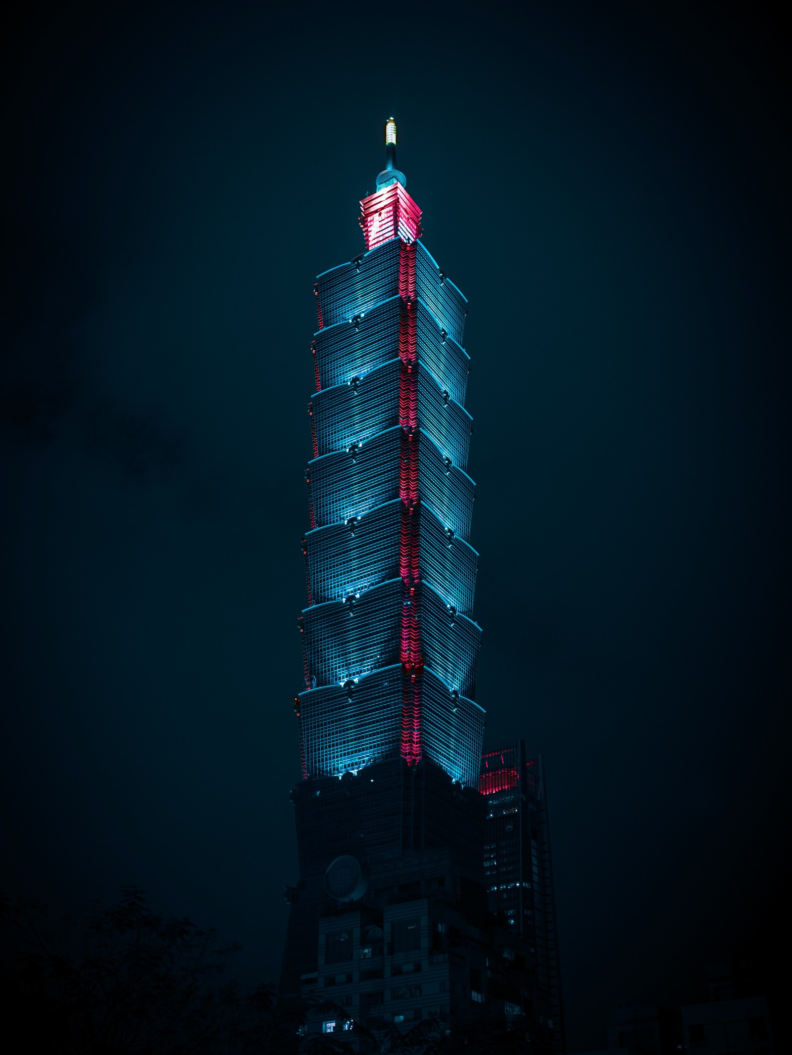 Arafed view of a tall building with a red light on top (skyscraper, building, tower, taipei 101, empire state building)