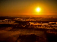 Golden Sunrise Over Misty Landscape