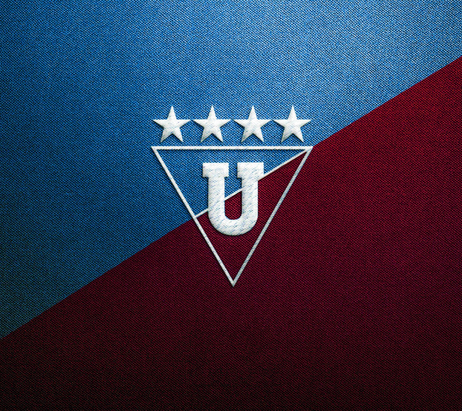 A close up of a soccer team logo on a blue and red background (ldu, liga de quito)