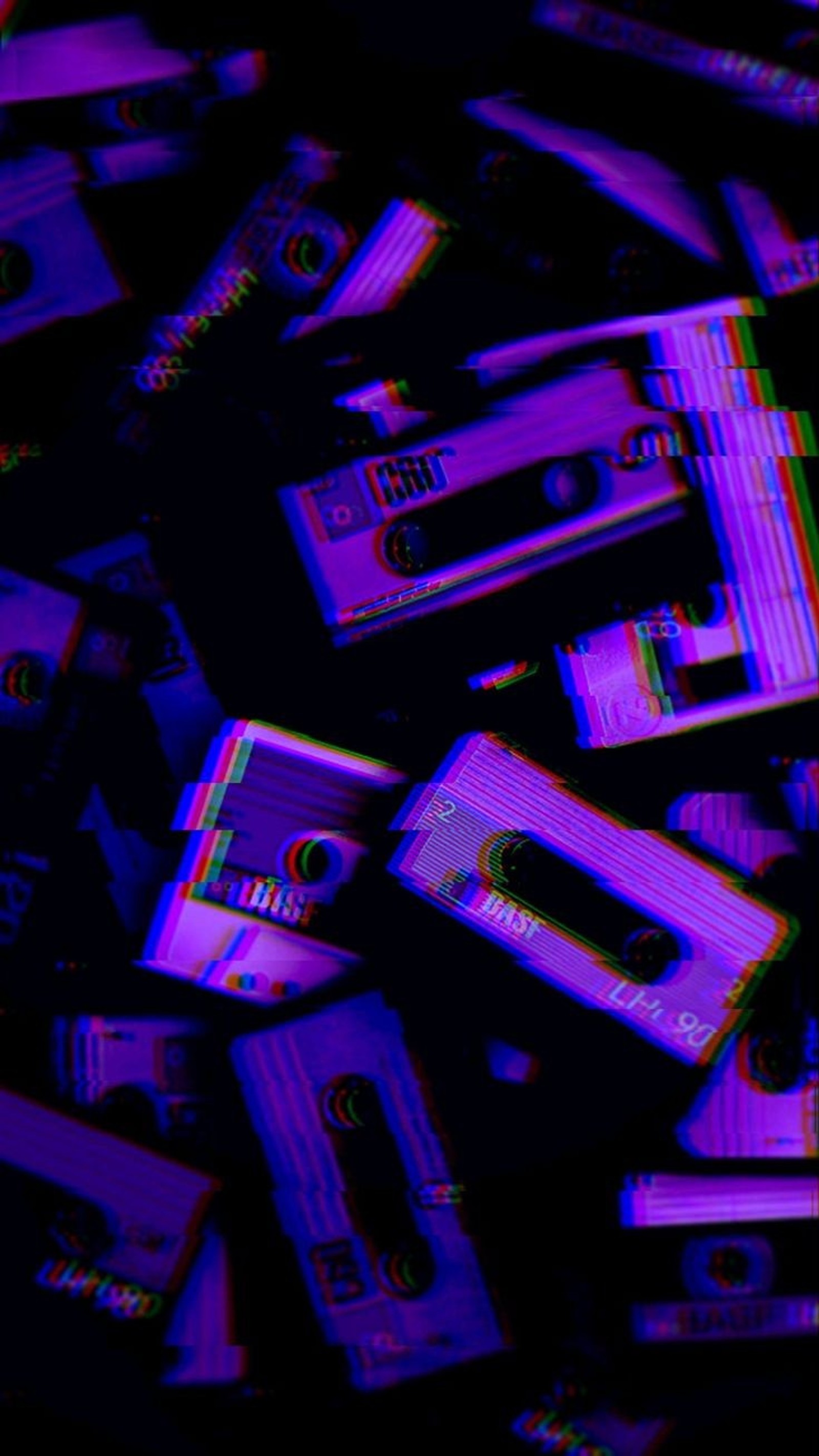 A close up of a pile of cassettes with a purple background (retro, type, vintage)