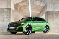 2020 Audi RS Q8 in striking green under modern architecture