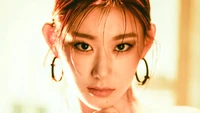 Chaeryeong from ITZY exudes confidence and allure in a striking close-up, showcasing her captivating gaze and bold style.