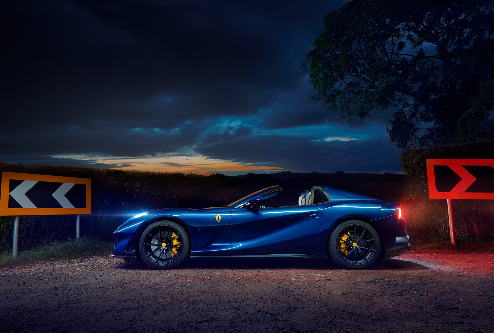 A close up of a blue sports car parked on a road (ferrari 812 gts, night, 5k, cars, 4k wallpaper)