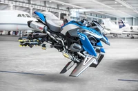 Futuristic BMW GS motorcycle in a sleek design, featuring advanced racing fairings and a dynamic stance, set against a high-tech aviation backdrop.