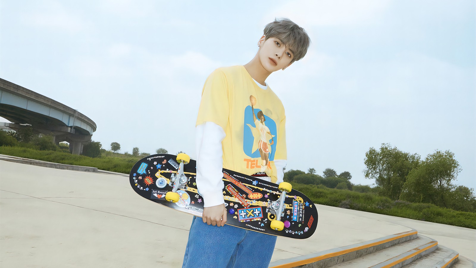 There is a young man holding a skateboard on a ramp (txt, kpop, 투모로우바이투게더, tomorrow x together, k pop)