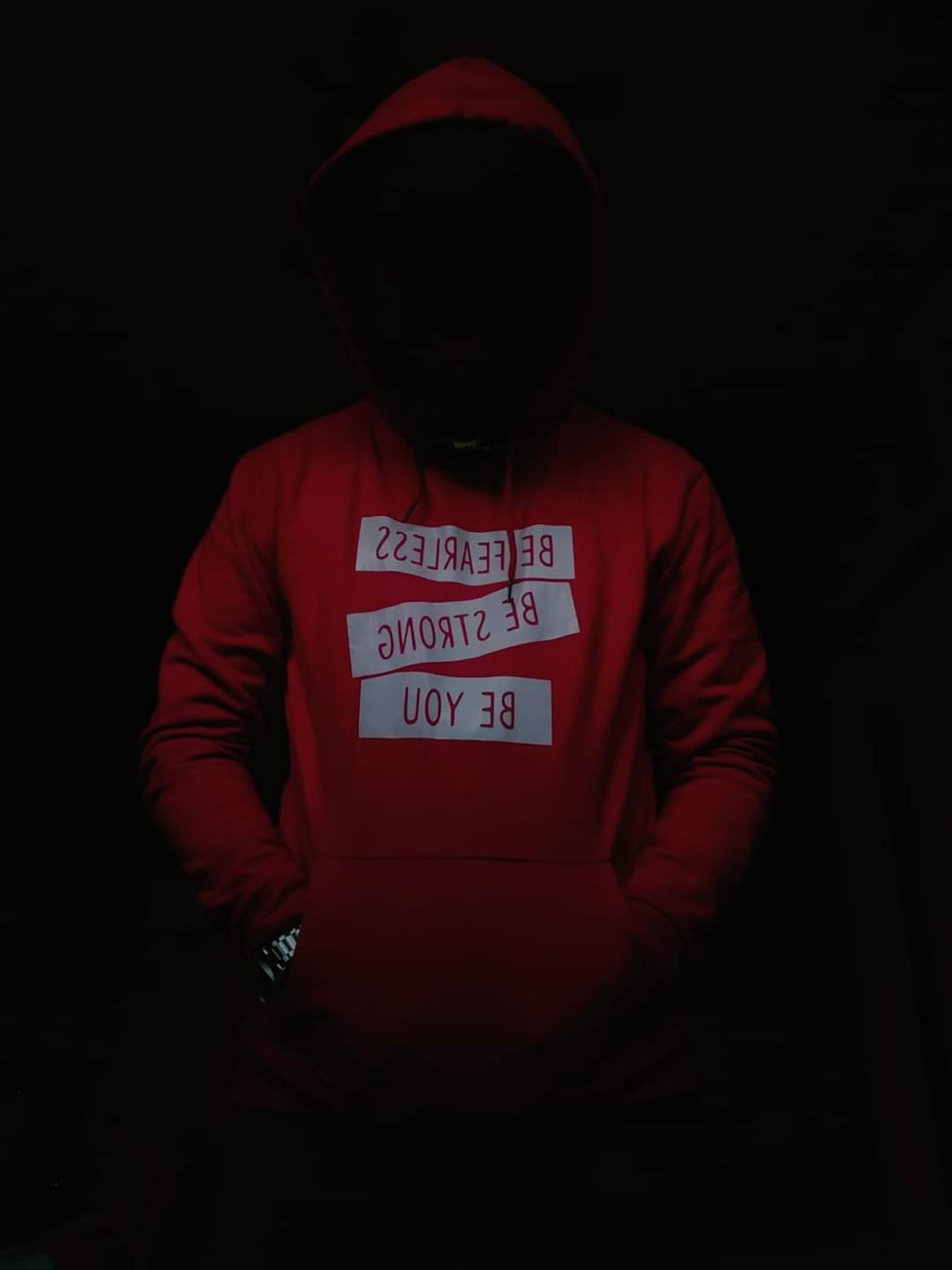 Arafed man in a red hoodie with a sign on it (amoled walpaper, boy, dark walpaper, hoodie, red)