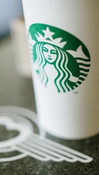 Starbucks-Becher mit ikonischem Logo auf einem Tisch