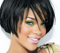 Rihanna with vibrant green eyeshadow and a chic short hairstyle, smiling confidently.