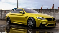 Elegante BMW M3 amarela com rodas personalizadas estacionada de forma estilosa contra um fundo urbano.