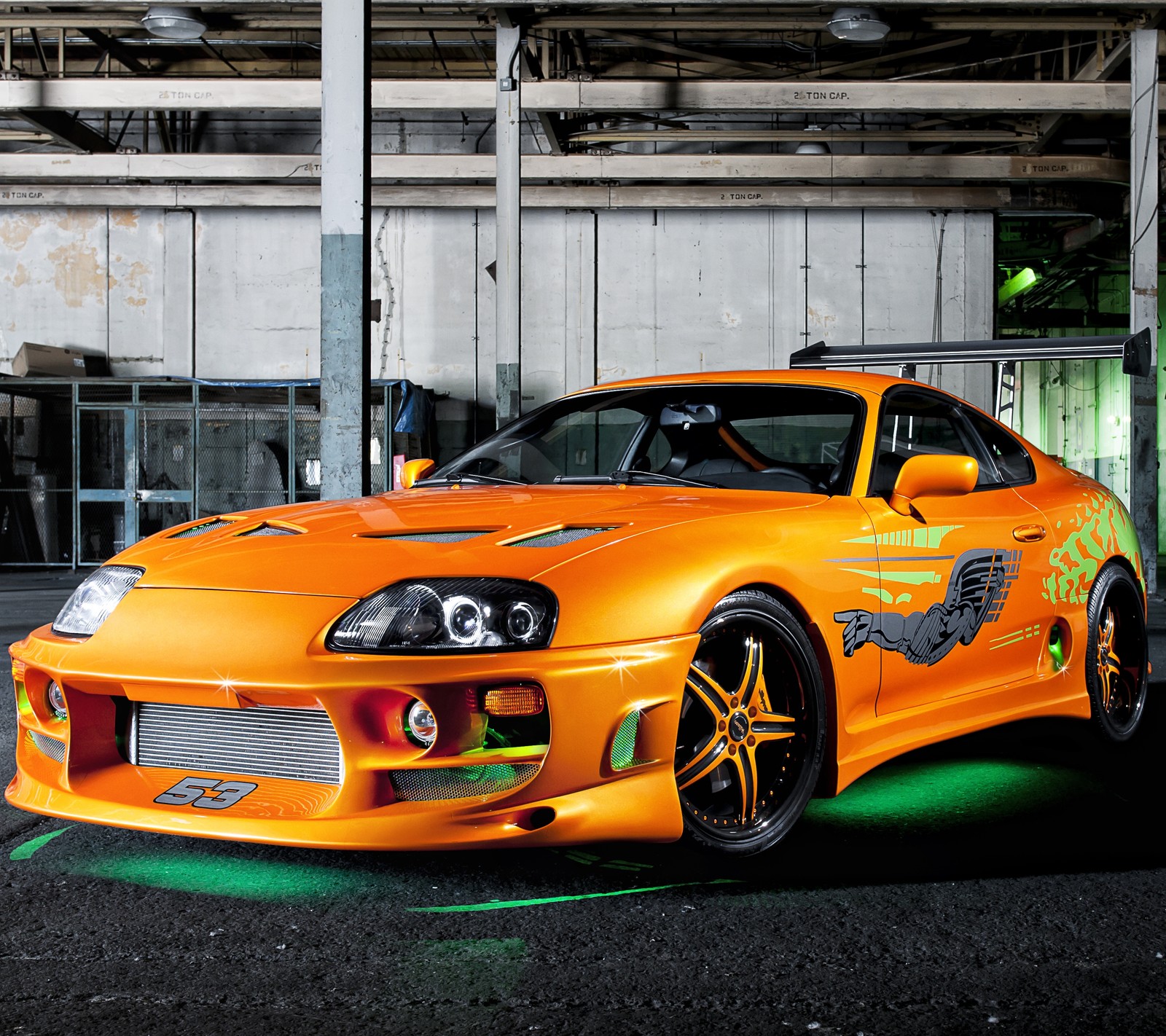 Arafed orange sports car parked in a garage with green lights (auto, car, supra, toyota)