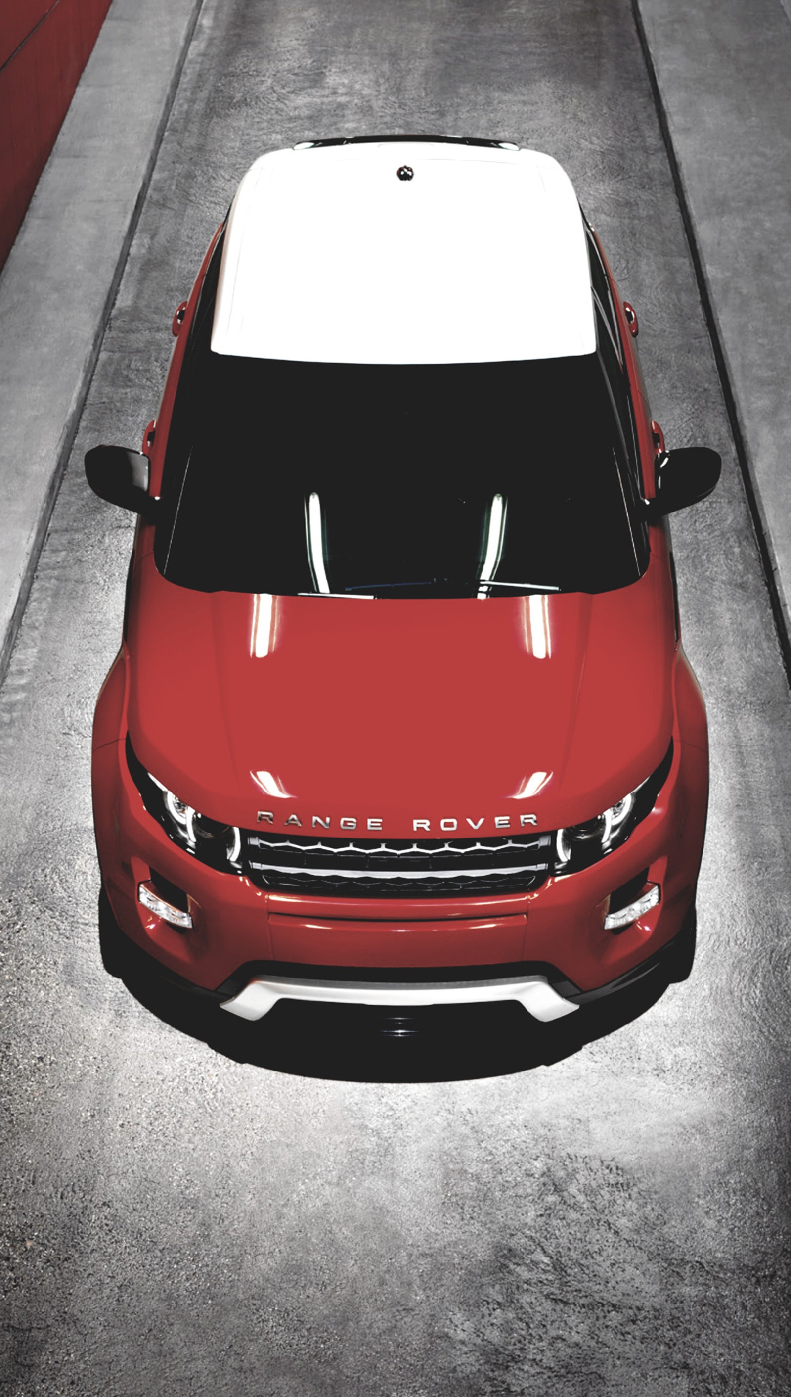 A close up of a red car parked on a street (car, range, rover)