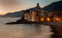 Coastal Resort Town at Dusk with Historic Castle Reflection