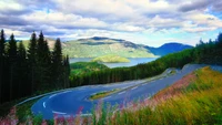 Curvy Mountain Road Overlooking Serene Lake