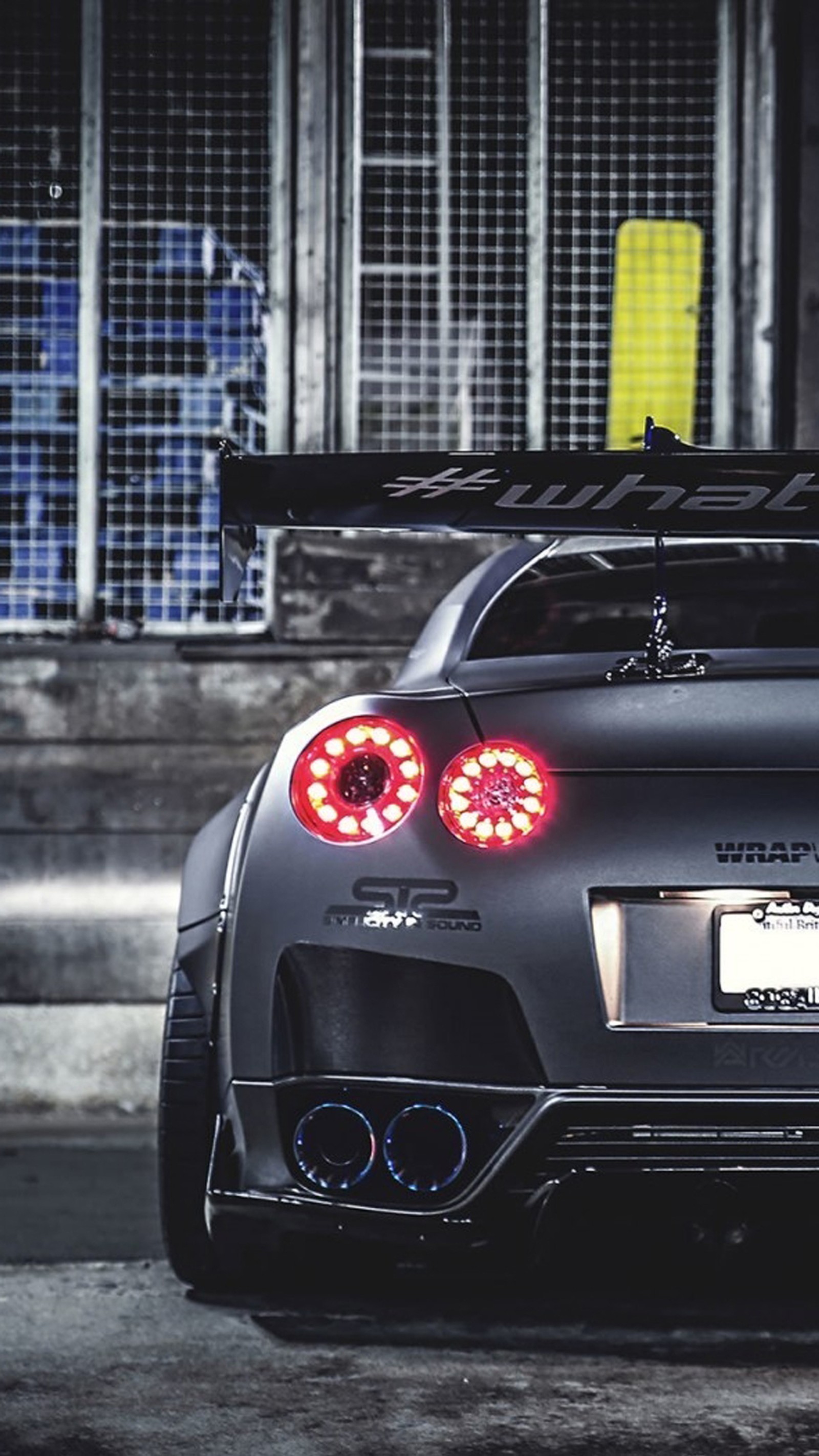 A close up of a car with its lights on in a parking lot (drift, gtr, japan, nissan, racing)